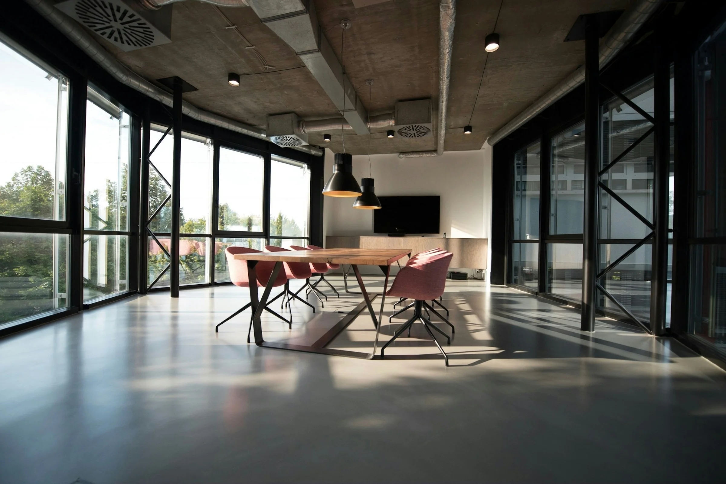 Sunlit glass meeting room in a contemporary agency workspace